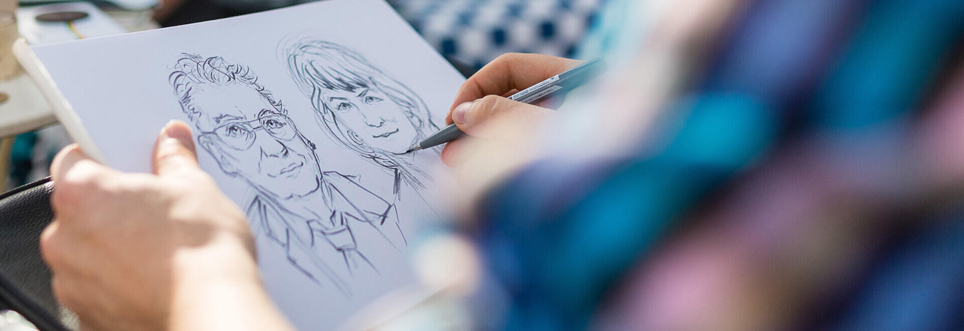 Live Caricature Portrait drawing at a company event of a couple with ink and pencil on A4 paper